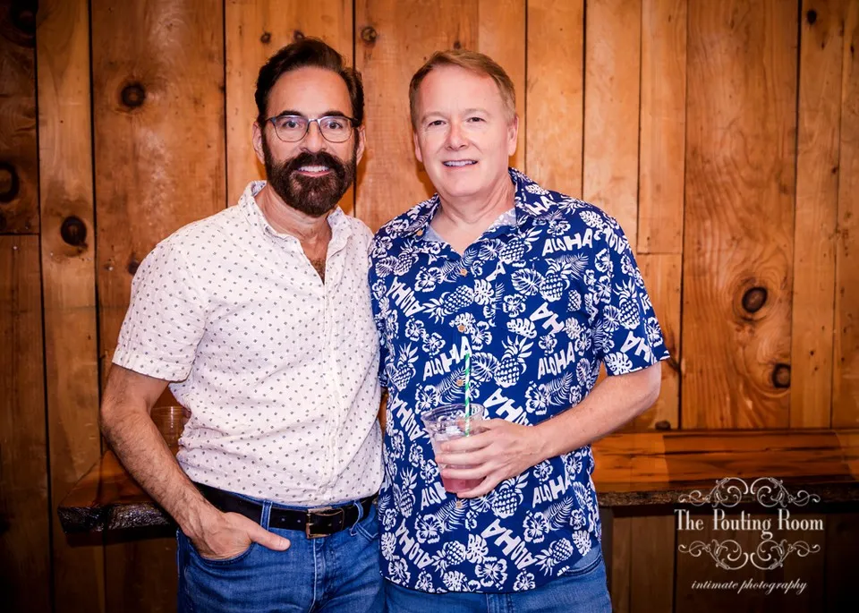 Two guests posing together by the bar at Dirty Tea