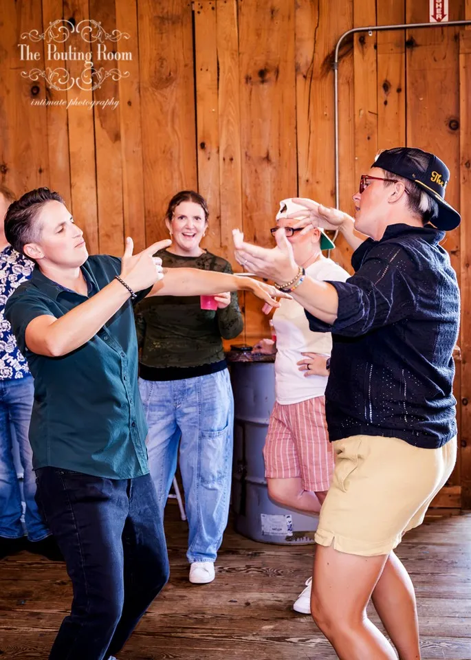 Friends dancing and pointing at each other on the floor at Dirty Tea