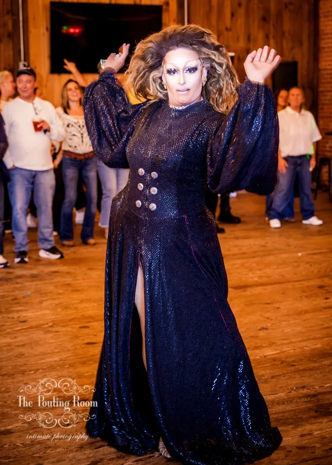 A drag performer in a sequined gown working the floor at Dirty Tea