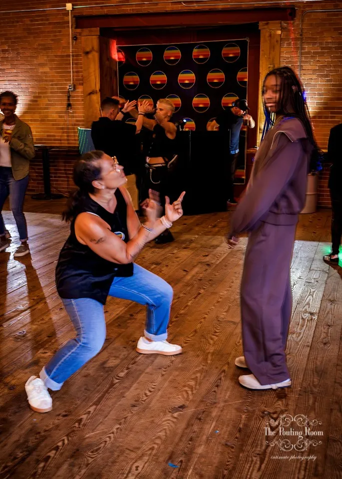 A guest dropping low to dance with a friend at Dirty Tea