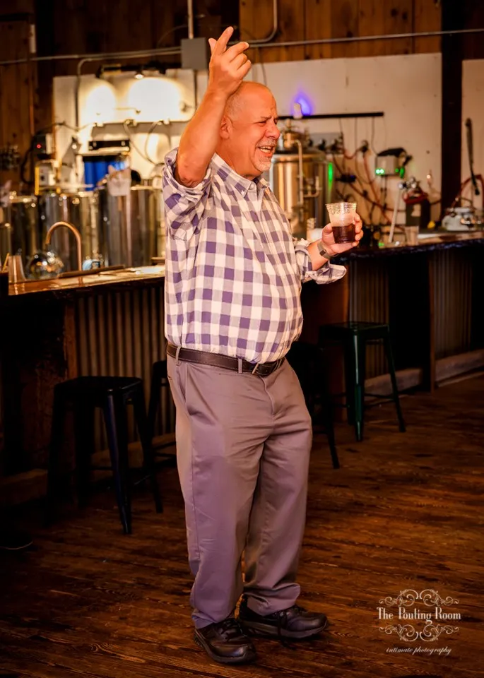 A guest mid-dance in front of the still house at Dirty Tea