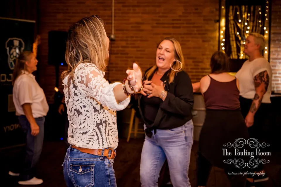 Two friends dancing face to face and singing at Dirty Tea