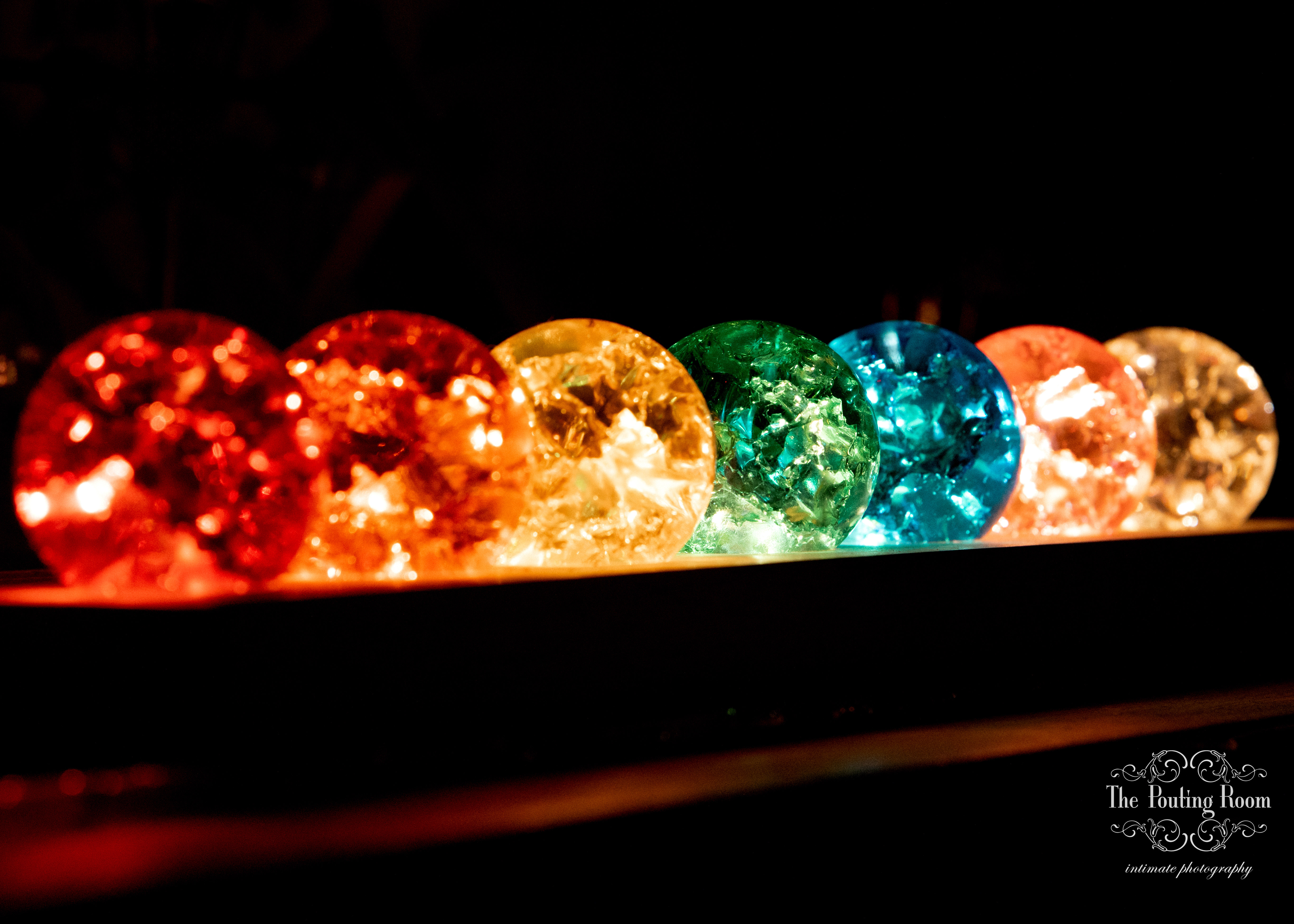 Rainbow-lit glass orbs decorating the venue