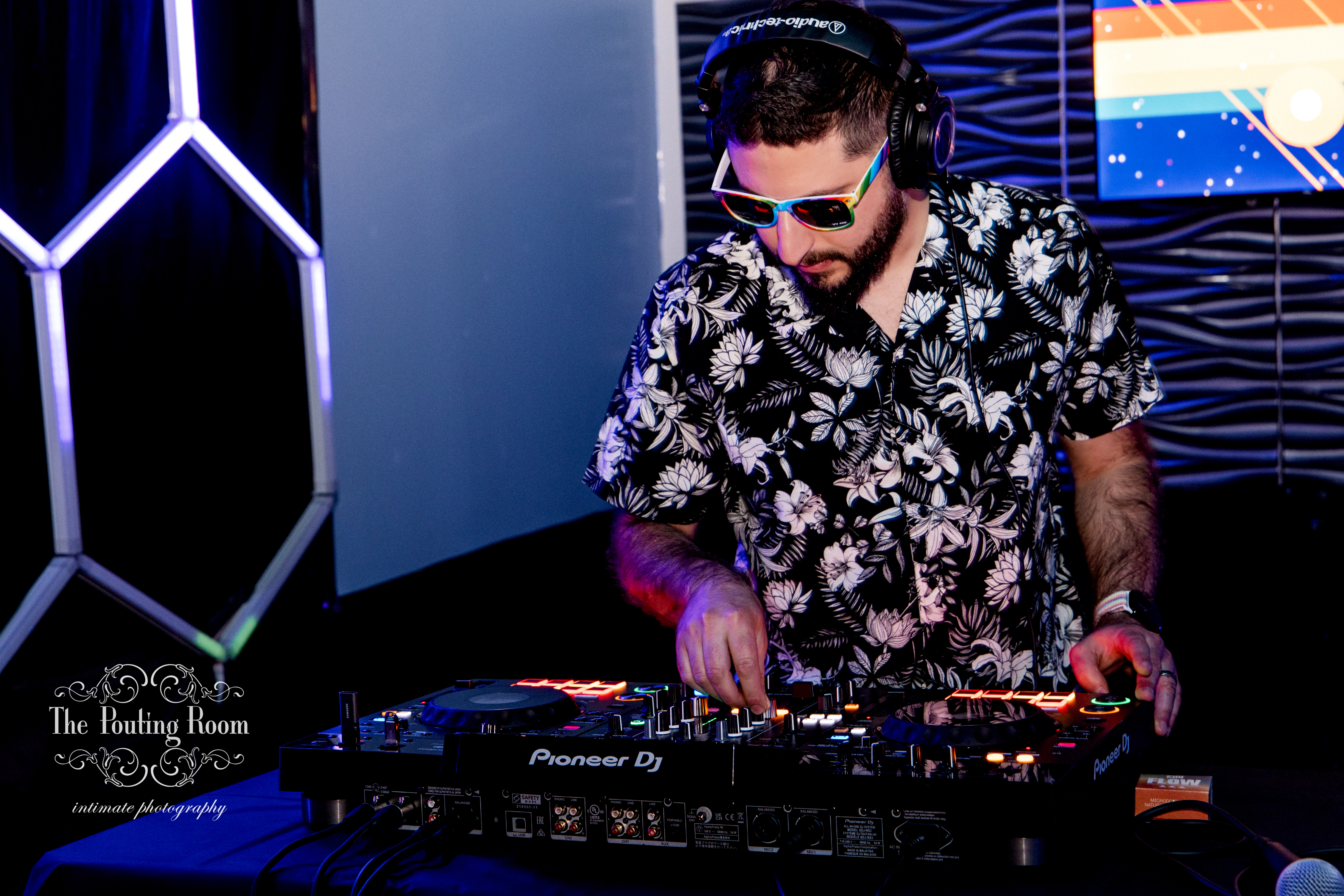 The DJ mixing with headphones at the Inaugural Tea Dance