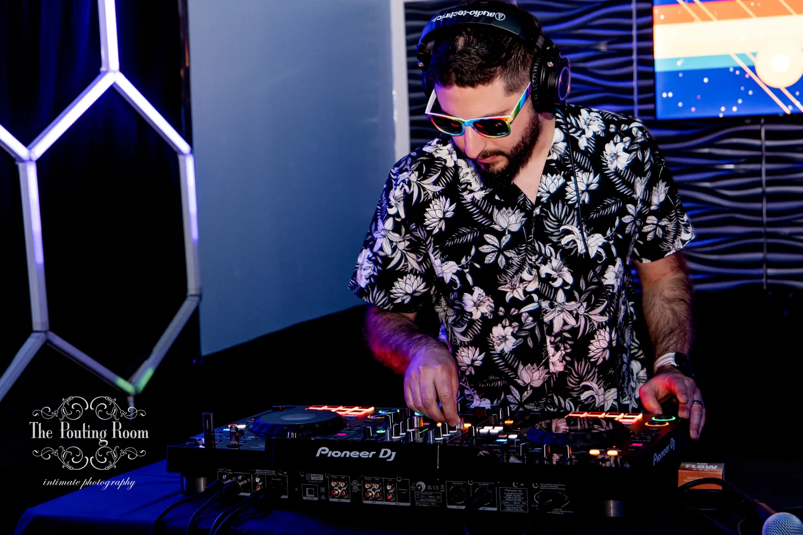The DJ mixing with headphones at the Inaugural Tea Dance