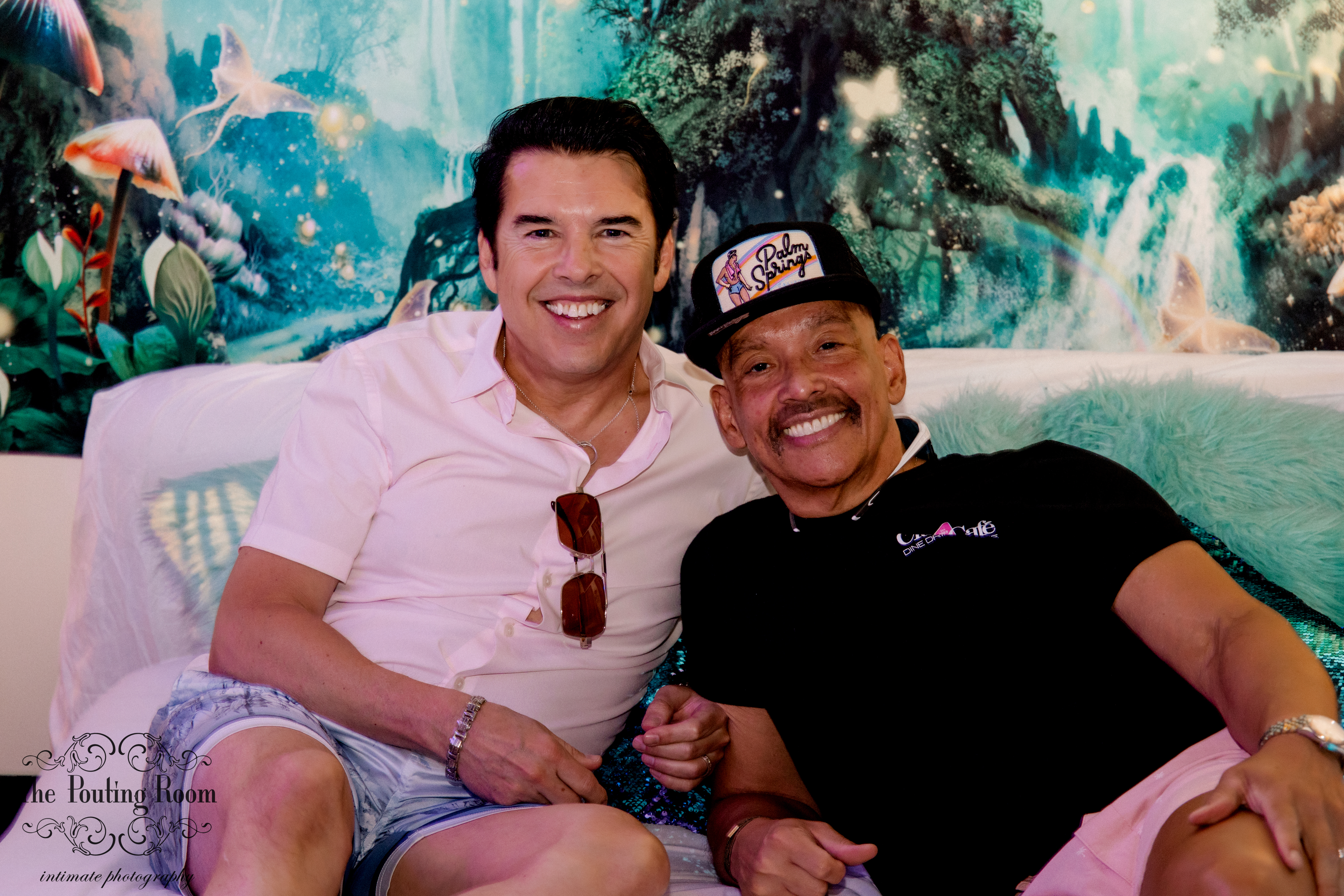 Two guests sharing a laugh on the lounge couch
