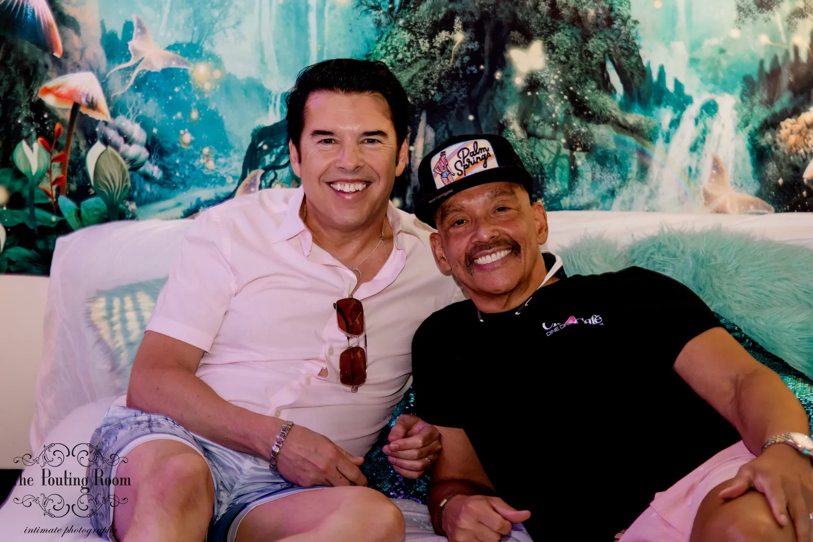 Two guests sharing a laugh on the lounge couch